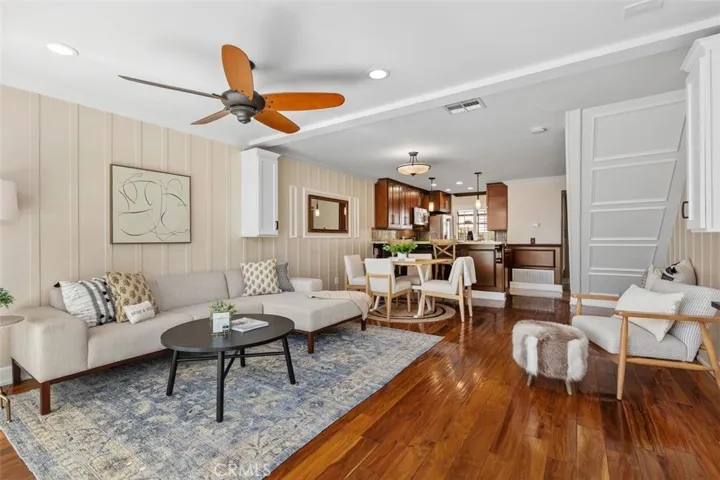 Living Room – Bright living space with a boxed staircase adding architectural interest.
