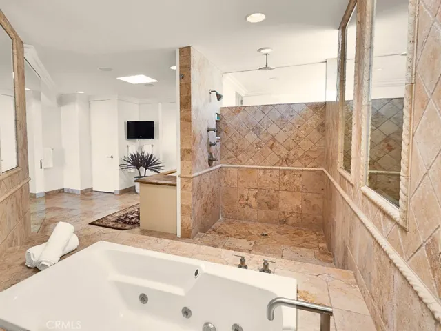 Spa-inspired bath with stone finishes and refined detailing.
