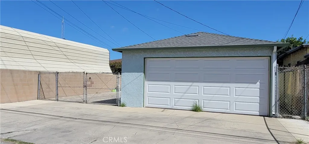 2 Car Garage and parking space for 4 sedans and Double Wide Swing Gate access.