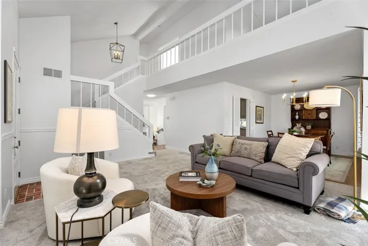 Vaulted ceilings and large windows encased in plantation shutters to greet you!