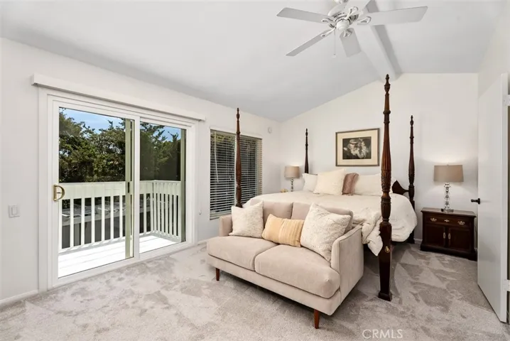 Sweet dreams await in this primary suite featuring airy ceilings and a cozy vibe!