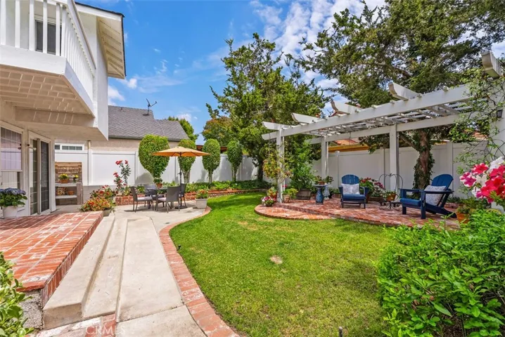 A true garden getaway! This wide perspective showcases the impressive scale and lush beauty of your private, oversized corner lot.