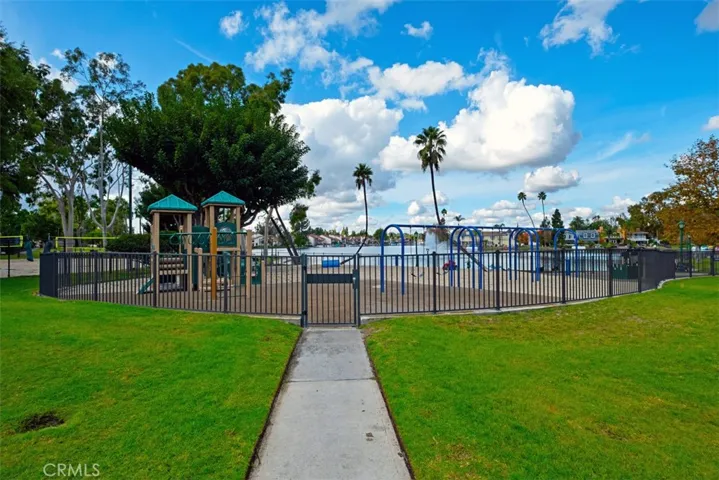 Peace of mind for parents! This gated lakeside tot lot offers a safe and scenic space for the little ones to climb, slide, and play.