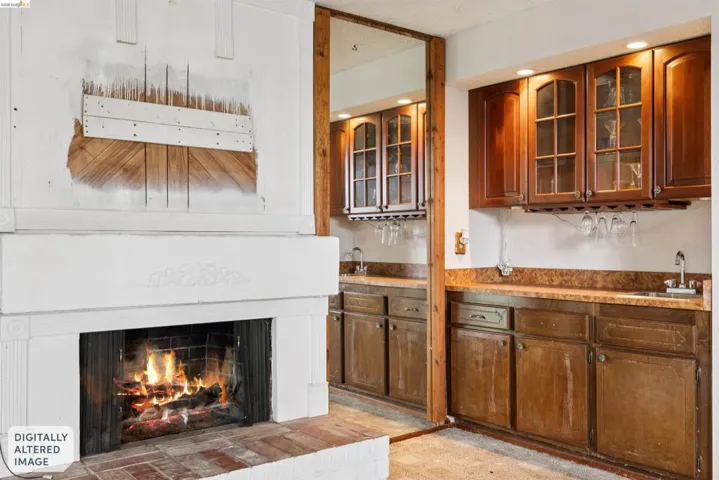 White-painted fireplace with an ornate mantel and brick hearth
