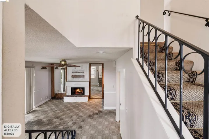 Staircase with ornamental metal railings and patterned carpet runner