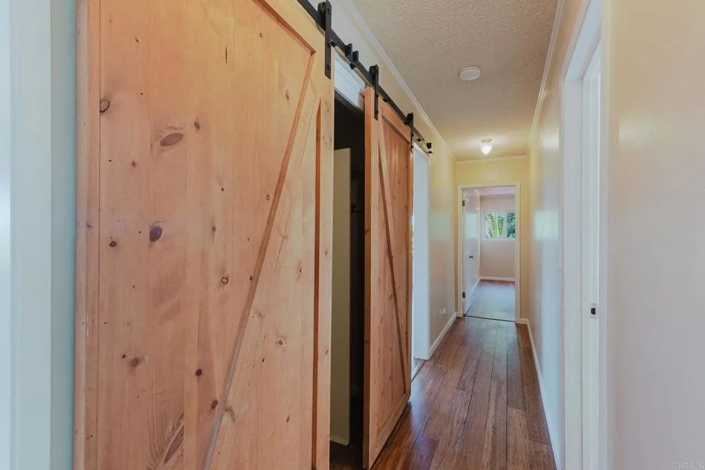 Hallway with barn doors for storage
