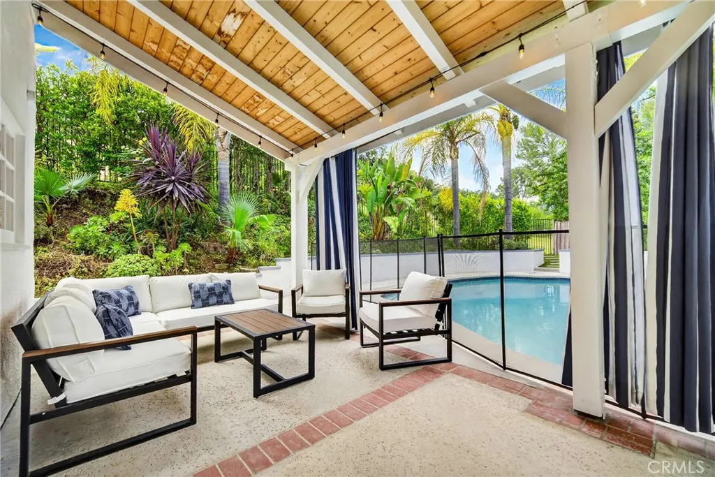 lovely garden with succulents, covered patio, security pool fence.