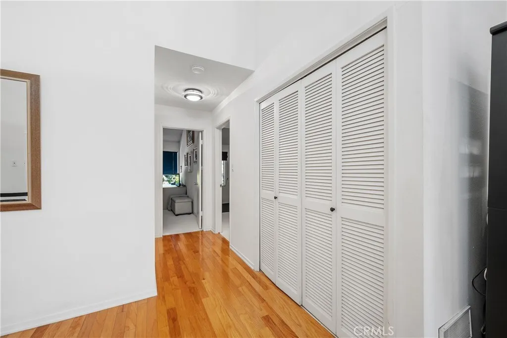 Hall leads to FULL bath, Primary en-suite, and the 2nd  bedroom.  Laundry is inside the bifold shutter doors. Washer/Dryer included.