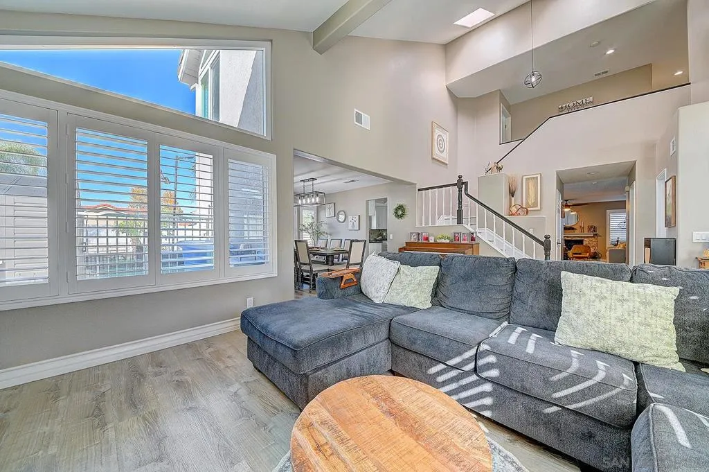 Soaring two-story ceilings, dramatic clerestory windows, and an open flow straight through to the dining room and staircase — the formal living room makes a statement every time.