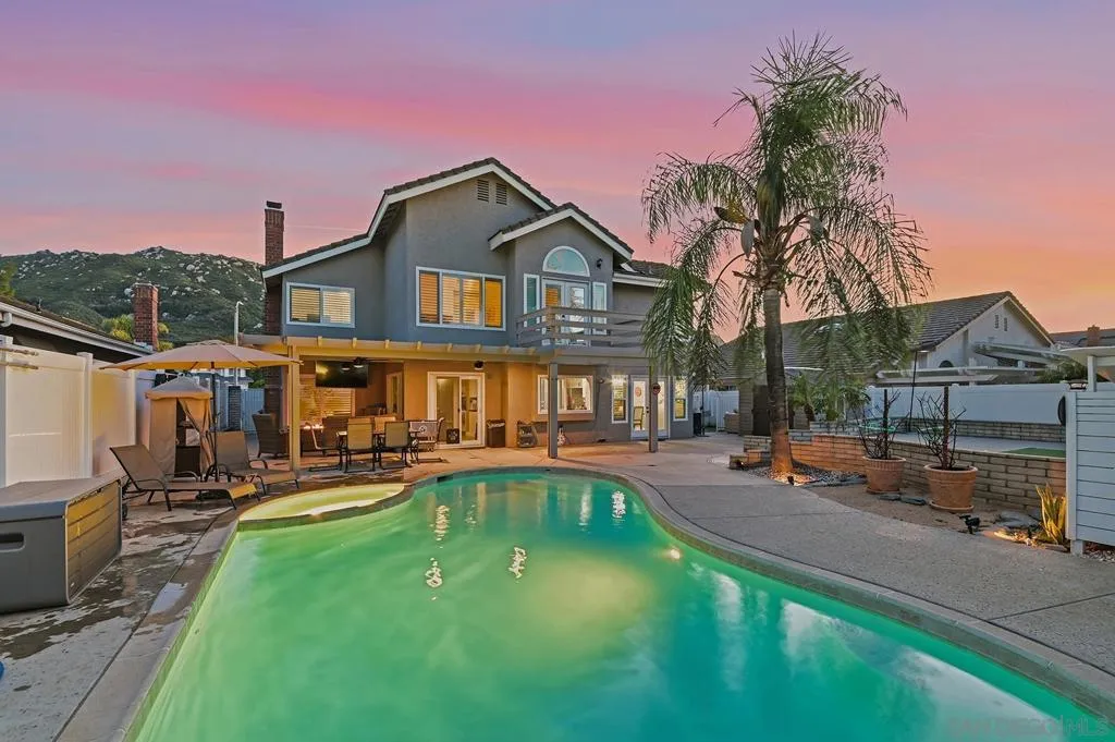 Your own private resort, right out the back door. Sparkling freeform pool and spa, swaying palms, covered pergola patio, and total privacy — the ultimate Southern California backyard built for unforgettable evenings and effortless entertaining.