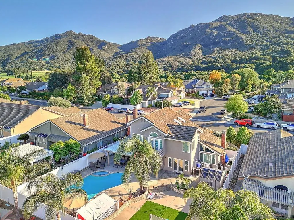 The view says it all. One of the largest lots in the neighborhood — pool, spa, lush palms, turf play area, and a sprawling entertainer’s backyard. Cul-de-sac privacy with breathtaking mountain views and room to live large.