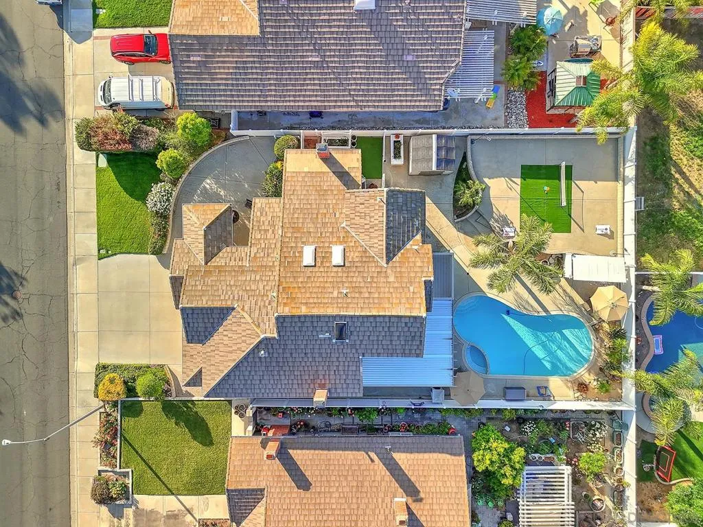 Rare overhead view reveals the full scope of this oversized lot. Pool, spa, covered patio, turf area, and generous hardscape — all within a fully enclosed private yard. Lot size like this is hard to find in South Temecula at any price.