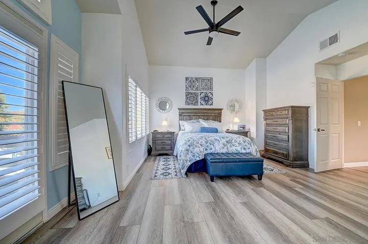 A true retreat. Vaulted ceilings, plantation shutters flooding the room with light, luxury vinyl plank flooring, and generous proportions — your personal sanctuary at the end of every day.