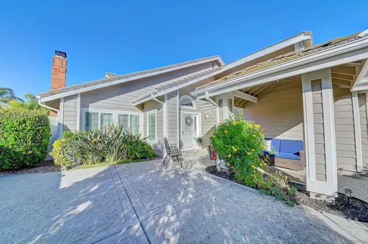 Your own private front courtyard — covered porch, lush landscaping, and a welcoming entry that sets this home apart from the street. Enjoy your morning coffee out front with breathtaking mountain views as your backdrop. This is curb appeal you can actuall