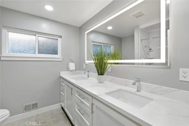 Designer bathroom finishes with custom built cabinetry.,