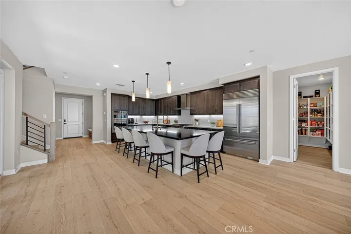 Wide open large kitchen and eating area. Beautiful upgrades and impeccable flooring.