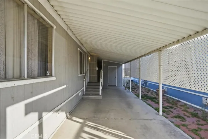 Spacious covered car port with shed