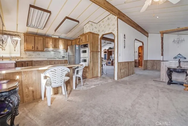 View to kitchen from 2nd living area. Island with bar area.  Double oven