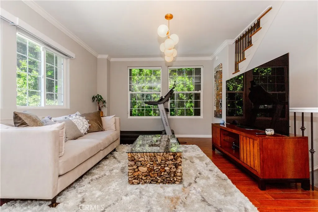 Light-filled living space with warm hardwood floors and effortless flow designed for both relaxing and entertaining.