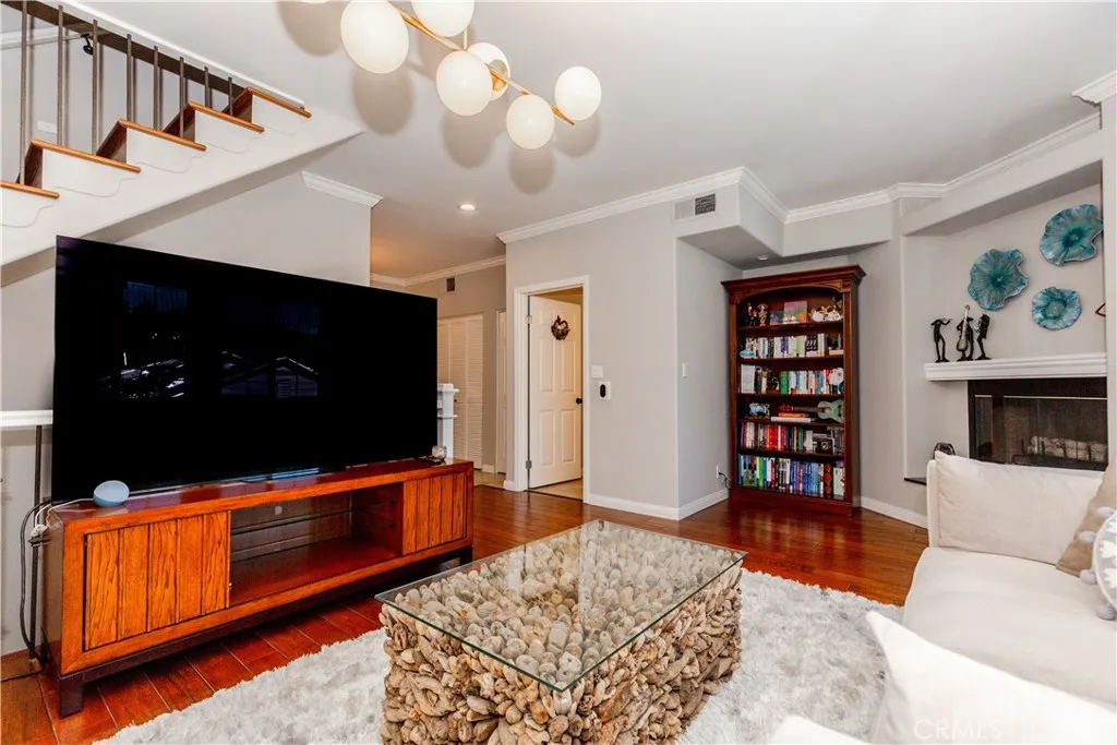 Light-filled living space with warm hardwood floors and effortless flow designed for both relaxing and entertaining.