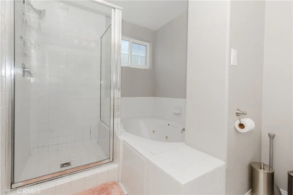 Spa-inspired primary bath with separate shower and soaking tub for a true unwind experience.