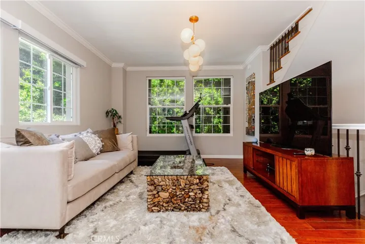 Light-filled living space with warm hardwood floors and effortless flow designed for both relaxing and entertaining.