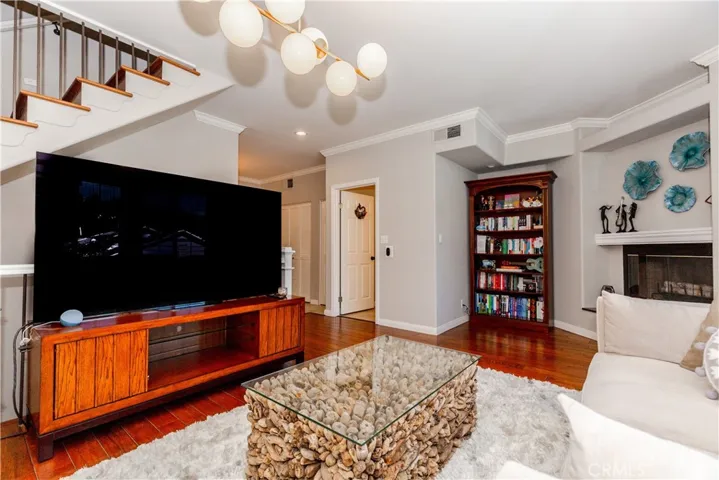 Light-filled living space with warm hardwood floors and effortless flow designed for both relaxing and entertaining.