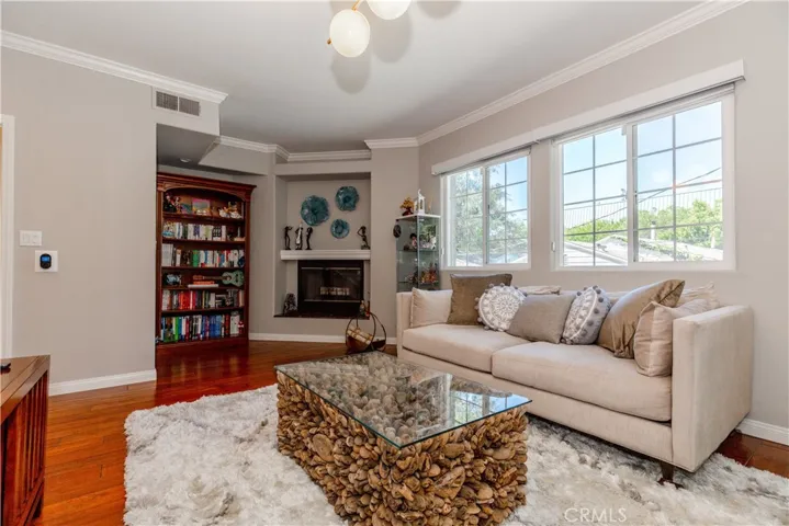 Light-filled living space with warm hardwood floors and effortless flow designed for both relaxing and entertaining.