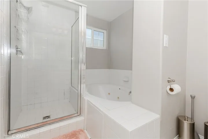 Spa-inspired primary bath with separate shower and soaking tub for a true unwind experience.