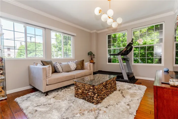 Light-filled living space with warm hardwood floors and effortless flow designed for both relaxing and entertaining.
