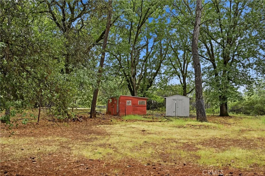 There are a number of storage buildings near close proximity to the the entrance gate and mobile home.