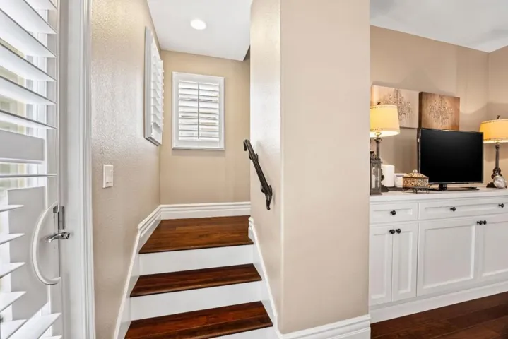 a beautiful stairwell leads up to two bedroom suite each with attached full bathrooms