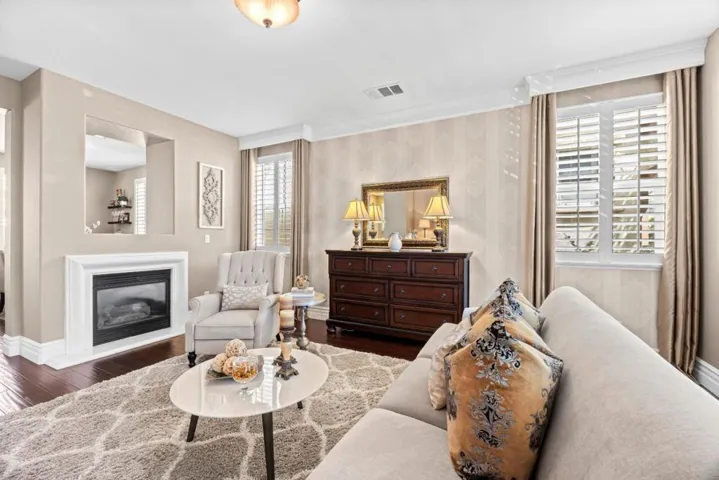 fireplace for cozy nights, designer touches boast wallpaper, valances, drapery, plantation shutters
