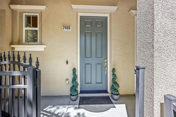perfectly manicured entrance welcomes you to this turn key home with rod iron gate and fencing
