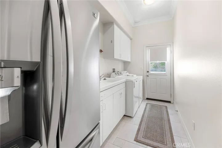 Laundry room with sink and room for a full size refrigerator