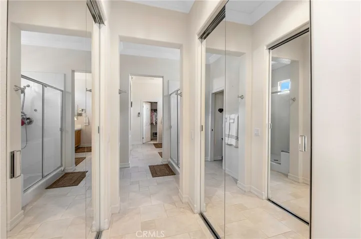 Hallway with 2 more closets with Mirrored Doors. Totaling 4 closets in the Master Suite
