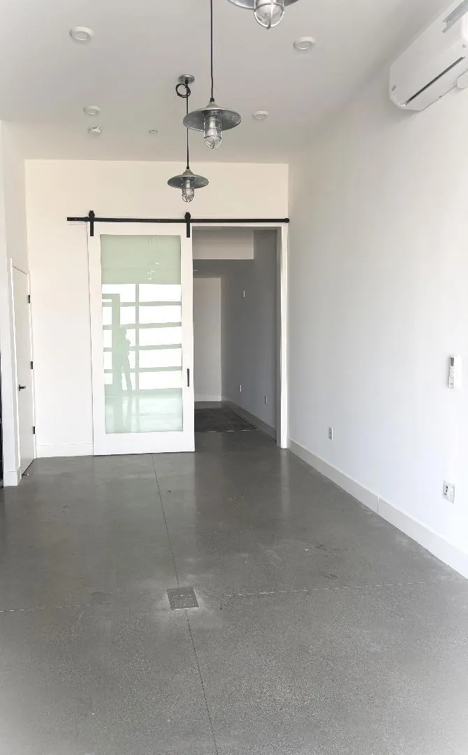 Downstairs, an additional room with a private room behind the sliding door and a full bathroom