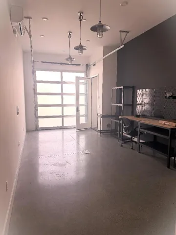 Another shot of the downstairs room with a rolling door for additional natural light and access.