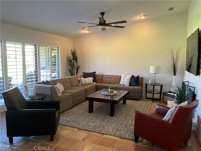 Great room with fireplace, high ceiling and large screen Smart TV off kitchen and dining room