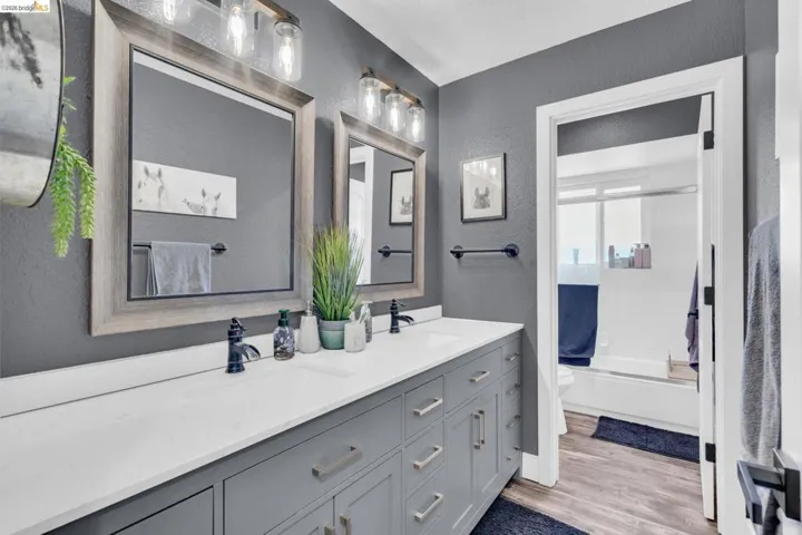 Dual vanity with white countertop, undermount sinks, and matte black faucets