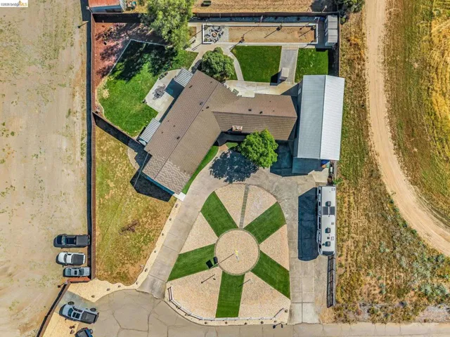 Circular driveway featuring a central turf and gravel design