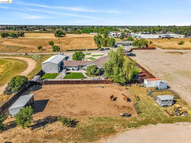 Expansive property featuring a ranch-style residence with a large metal workshop