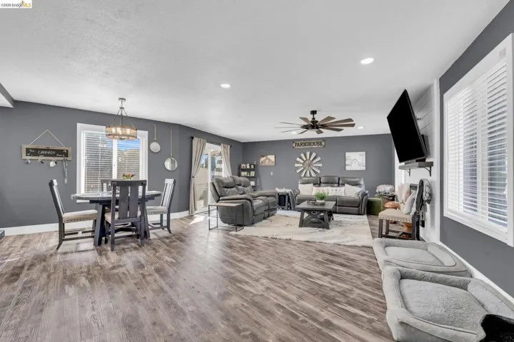 Open-concept interior featuring wood-finish flooring, recessed lighting, and a modern ceiling fan
