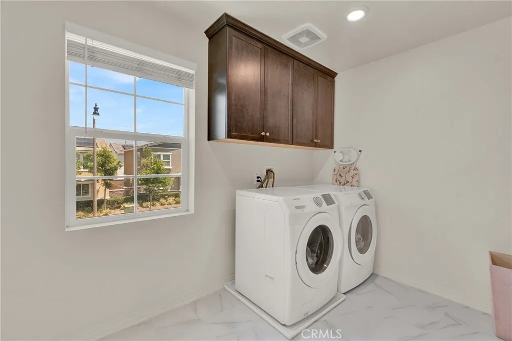 Upstairs laundry room with storage