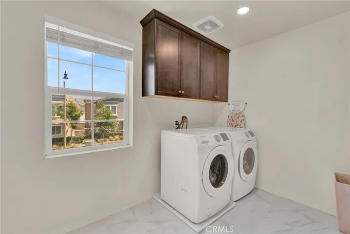 Upstairs laundry room with storage