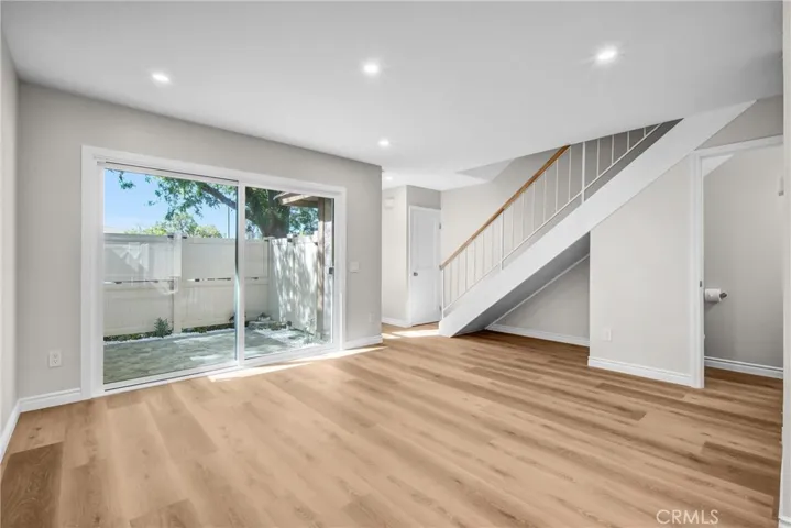 Living Area, Sliding Door 
to Patio, Staircase