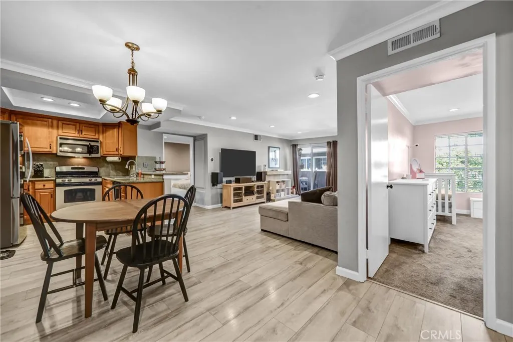 Unit entry with view of dinning area and secondary bedroom