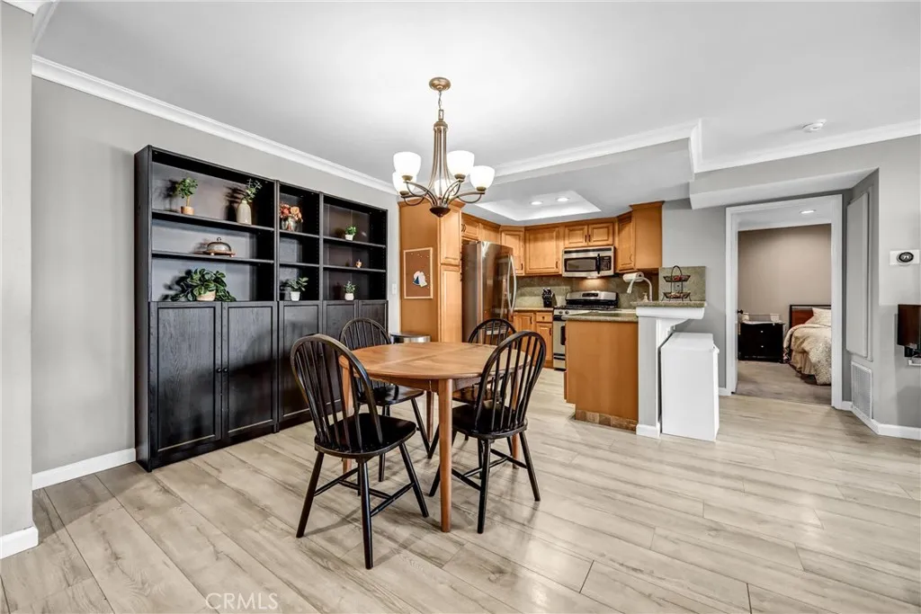 Dining area with kitchen and primary bedroom