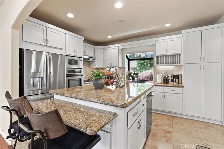 The breakfast bar is a perfect place to relax while keeping the cook company!