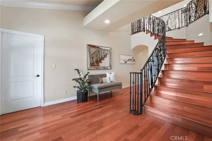 Enjoy the gorgeous wood flooring and beautiful staircase with decorative wrought iron banister.